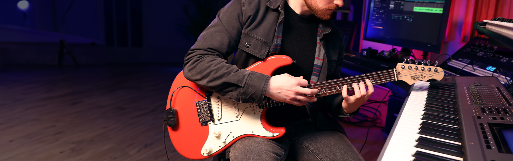 Guitar player in music studio with TriplePlay Express on electric guitar